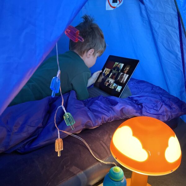 Cubs still manage to camp indoors during the pandemic. Tis cub joins the group Zoom call from inside his indoor tent.